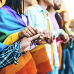 Group of lgbt people holding hands outside – Diverse happy frien